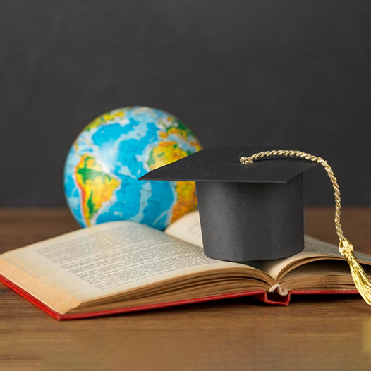 Graduation cap and globe symbolizing global education guided by Australia immigration consultants in Kerala